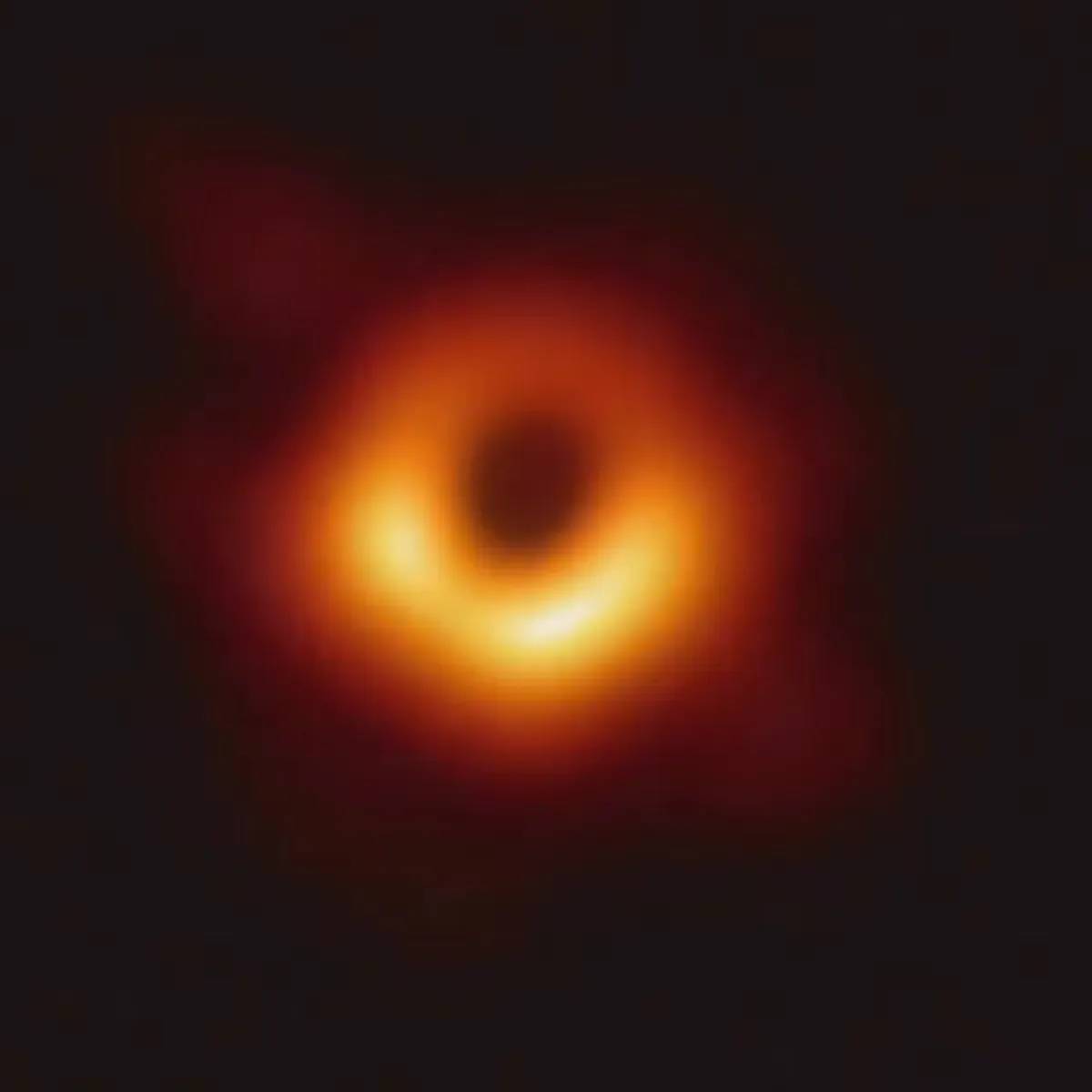 A dark center ringed by glowing orange light